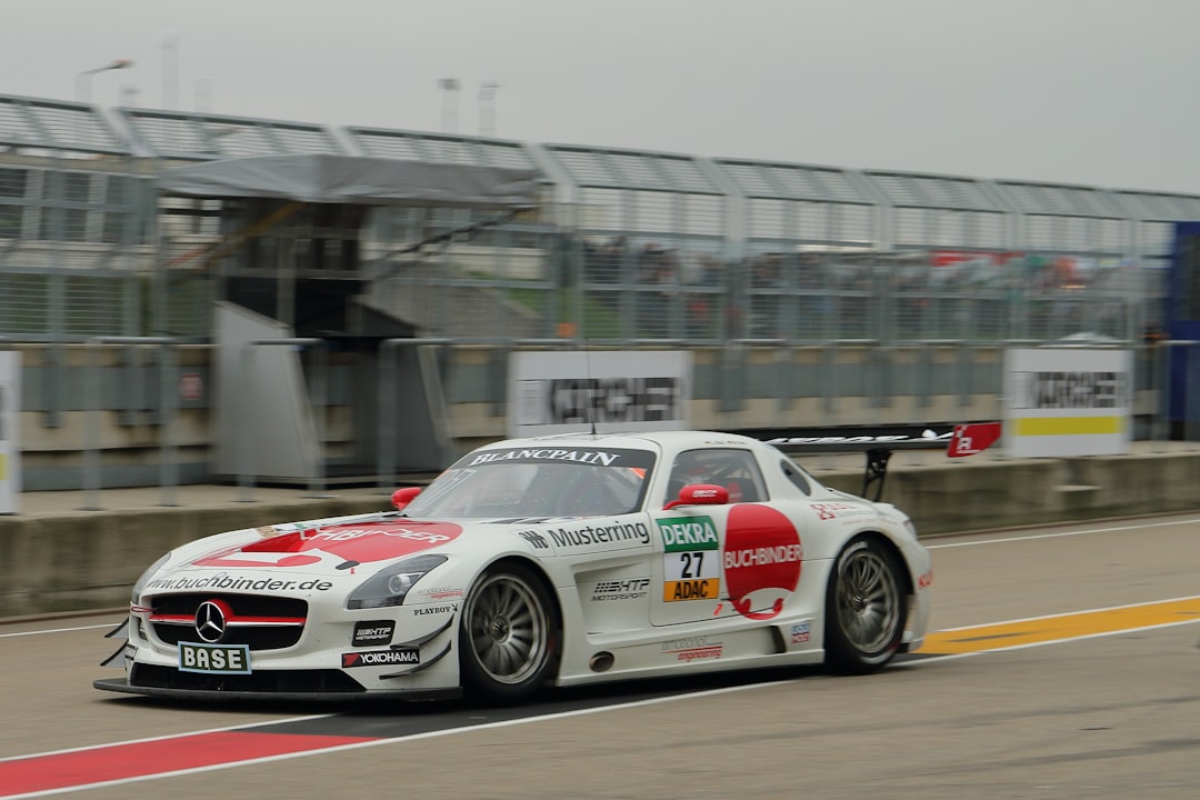 white and red Mercedes-Benz car on road, This shot was taken on the pit lane of the Sachsenring in 2014 at the ADAC GT-Masers racing event.</p>
<p style="text-align: left; margin-bottom: 1em;">Racing Team name: H.T.P. Motorsport
