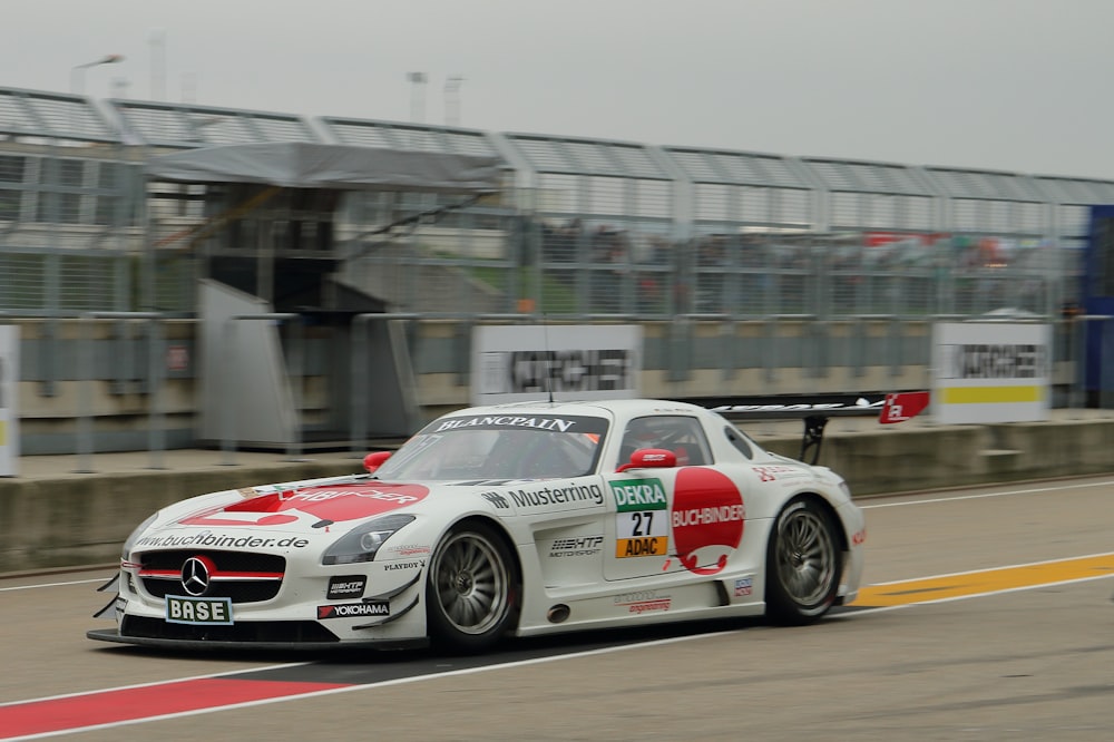 white and red Mercedes-Benz car on road