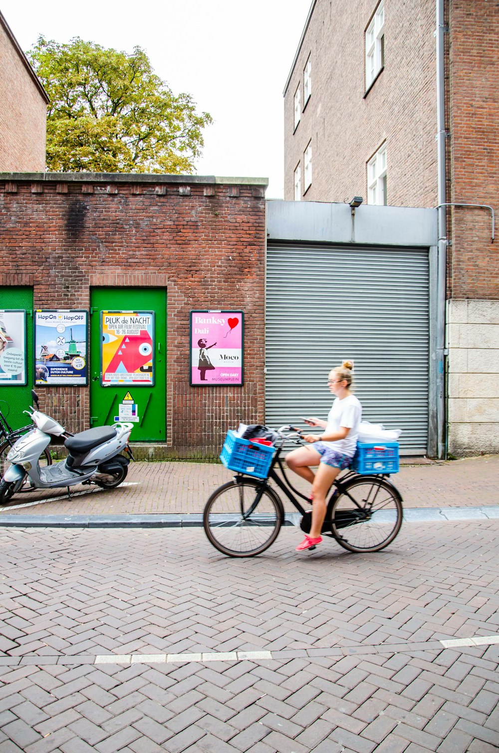 woman riding black step-through bike on street