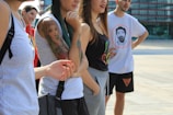 A diverse group of young adults wearing casual urban clothing outdoors.