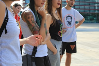 A diverse group of young adults wearing trendy casual clothes in an urban setting.
