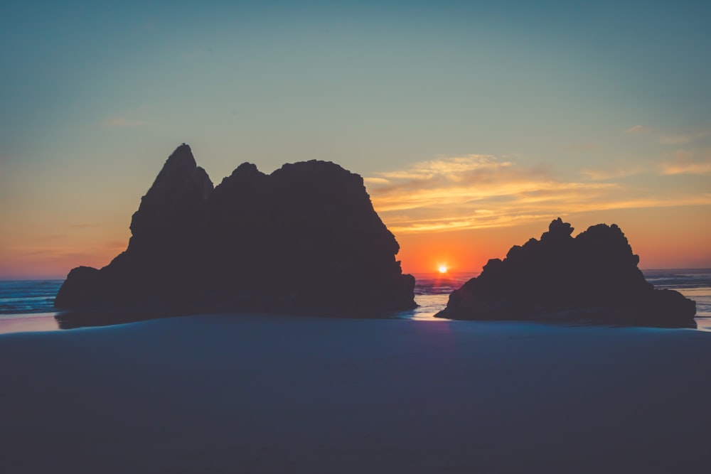 silhouette of island during sunset