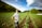 A happy customer standing in a lush farmland.