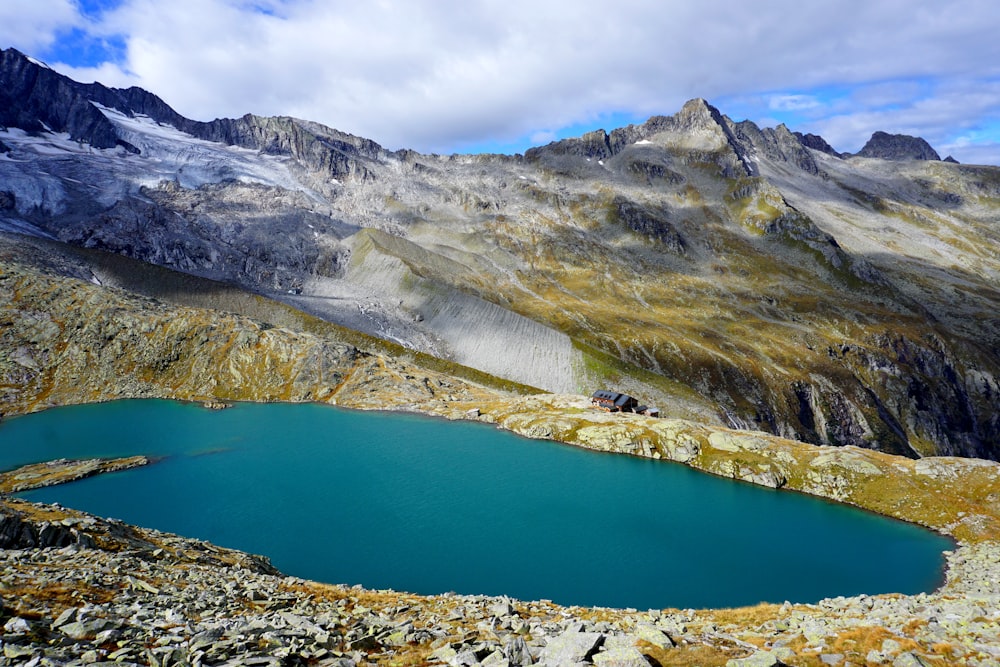 lake surrounded by mountain landscape during daytime