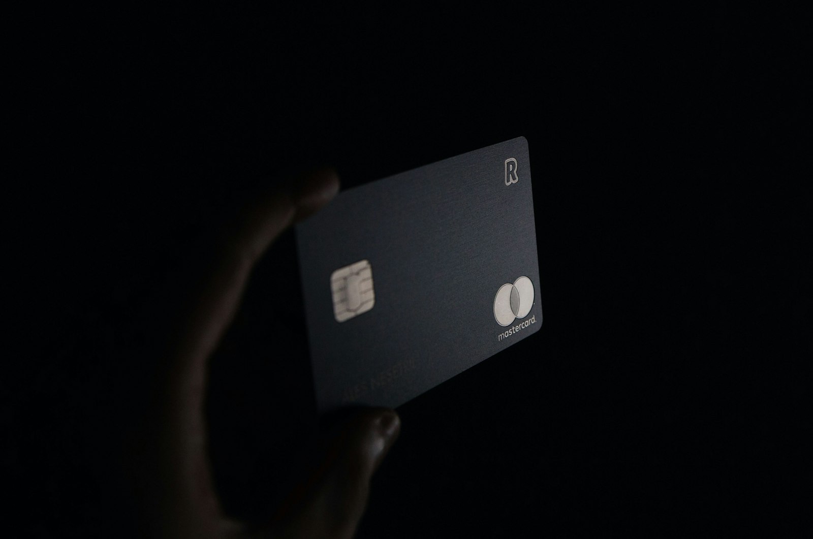 Three premium credit cards fanned out on a dark surface