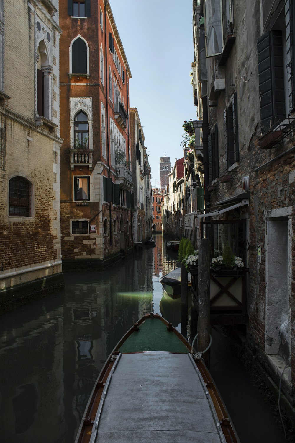 boat on body of water in middle of buildings