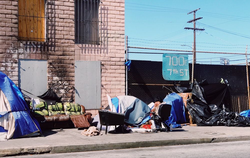 blue tarps beside brown concrete building