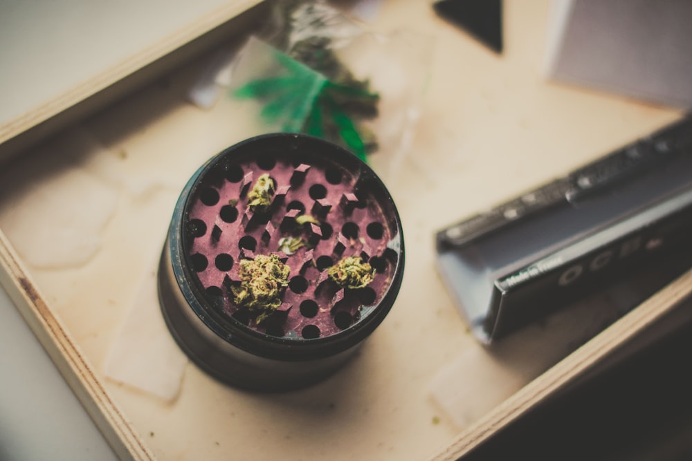 red and black herb grinder