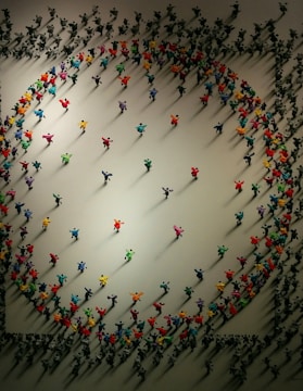 Top view of vibrant miniature figures arranged in a display case.