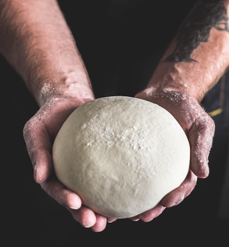 person holding dough