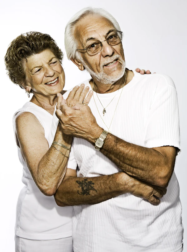 An older couple standing arm in arm