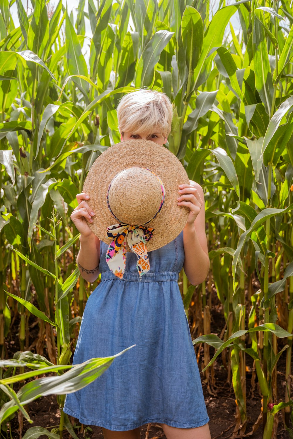 woman holding sun hat