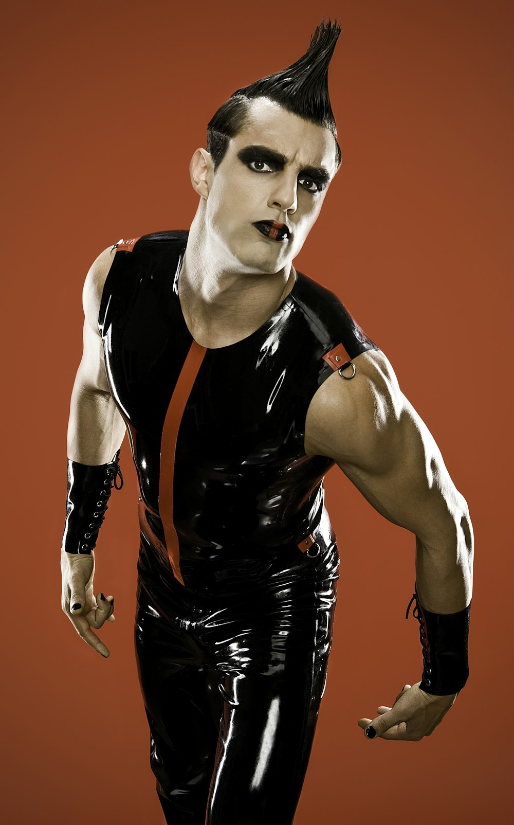 man wearing black latex sleeveless shirt and pants