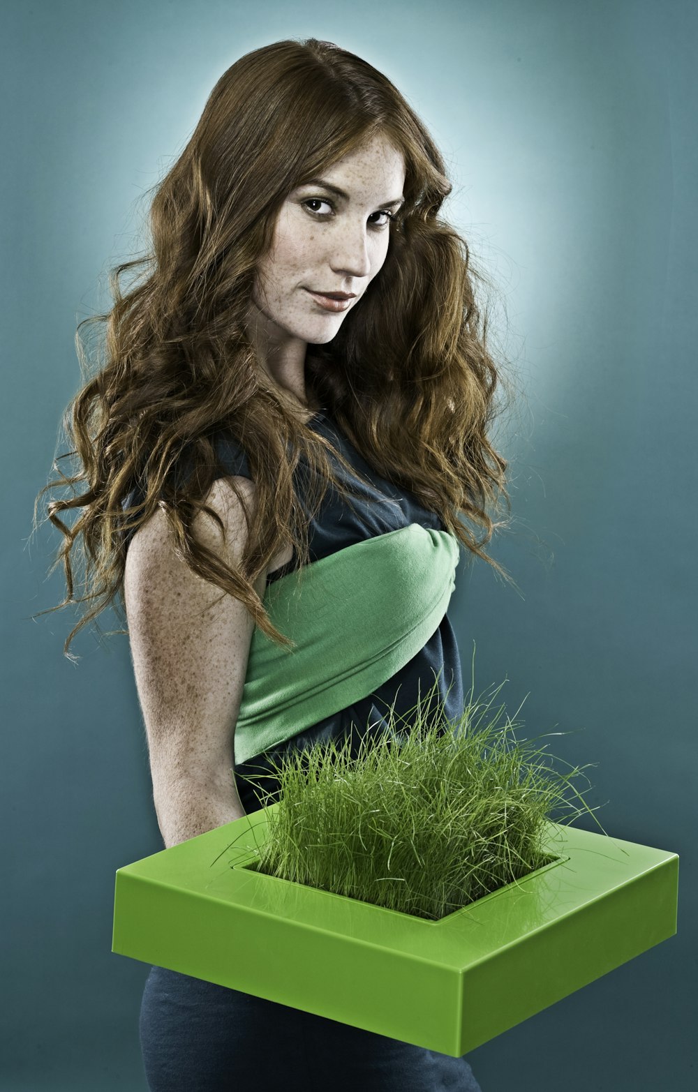 woman holding green grass