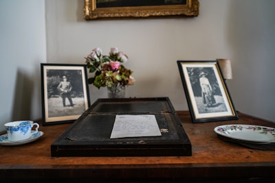Close-up of a framed picture of a cherished family member on a wooden table.