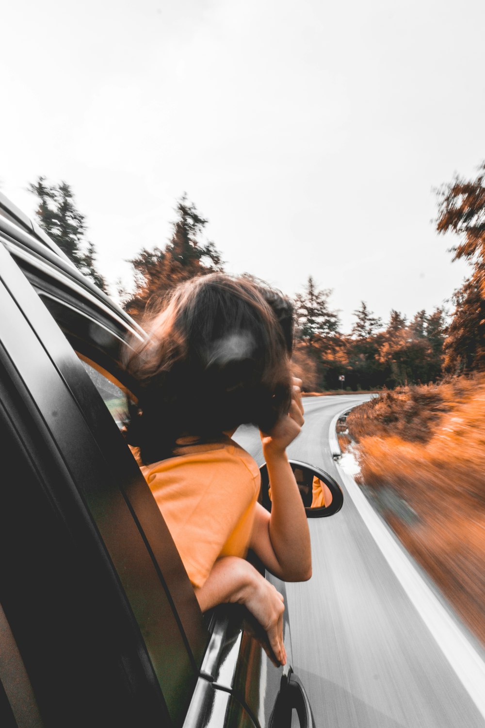 woman looking out vehicle window