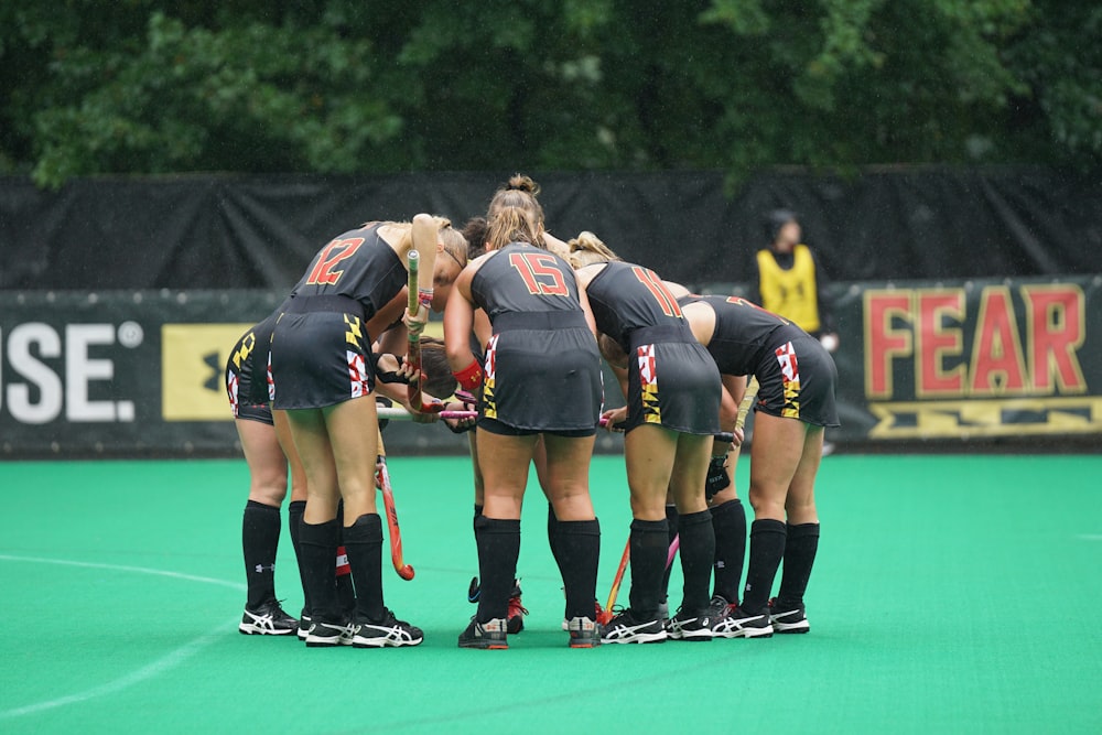 group of women team standing on green floor