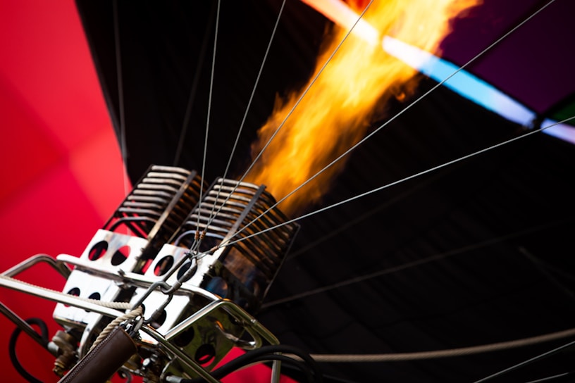 Close-up of a complex industrial burner system in operation with visible flames.