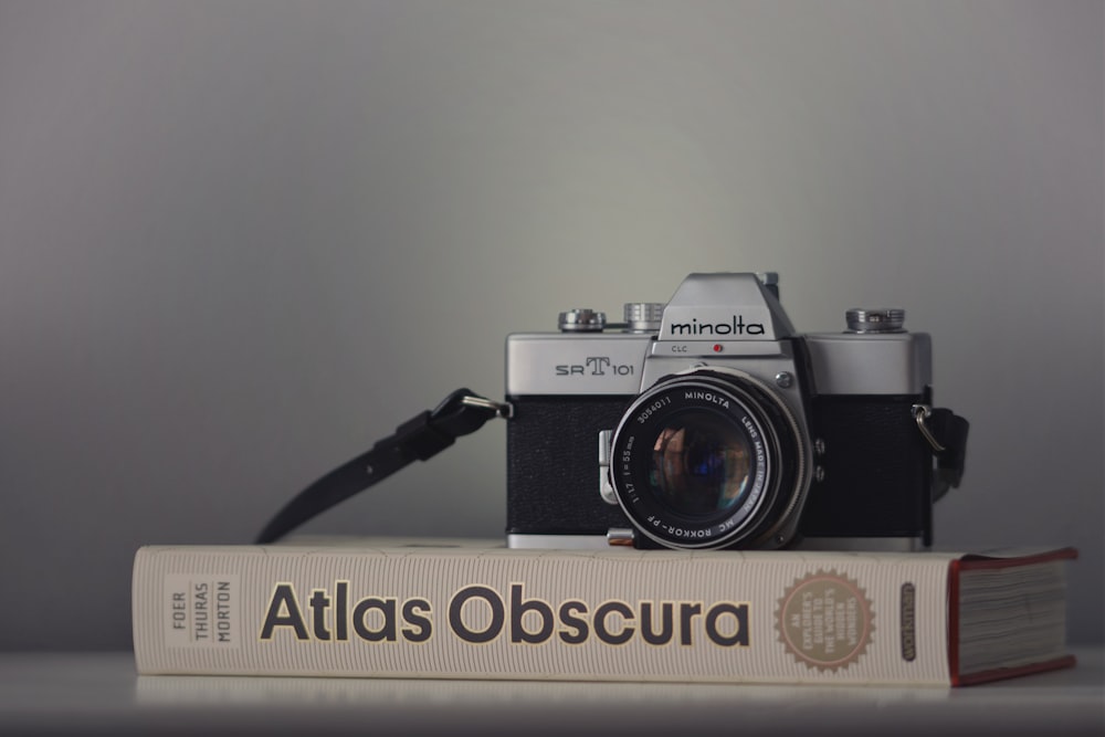 gray Minolta camera on book