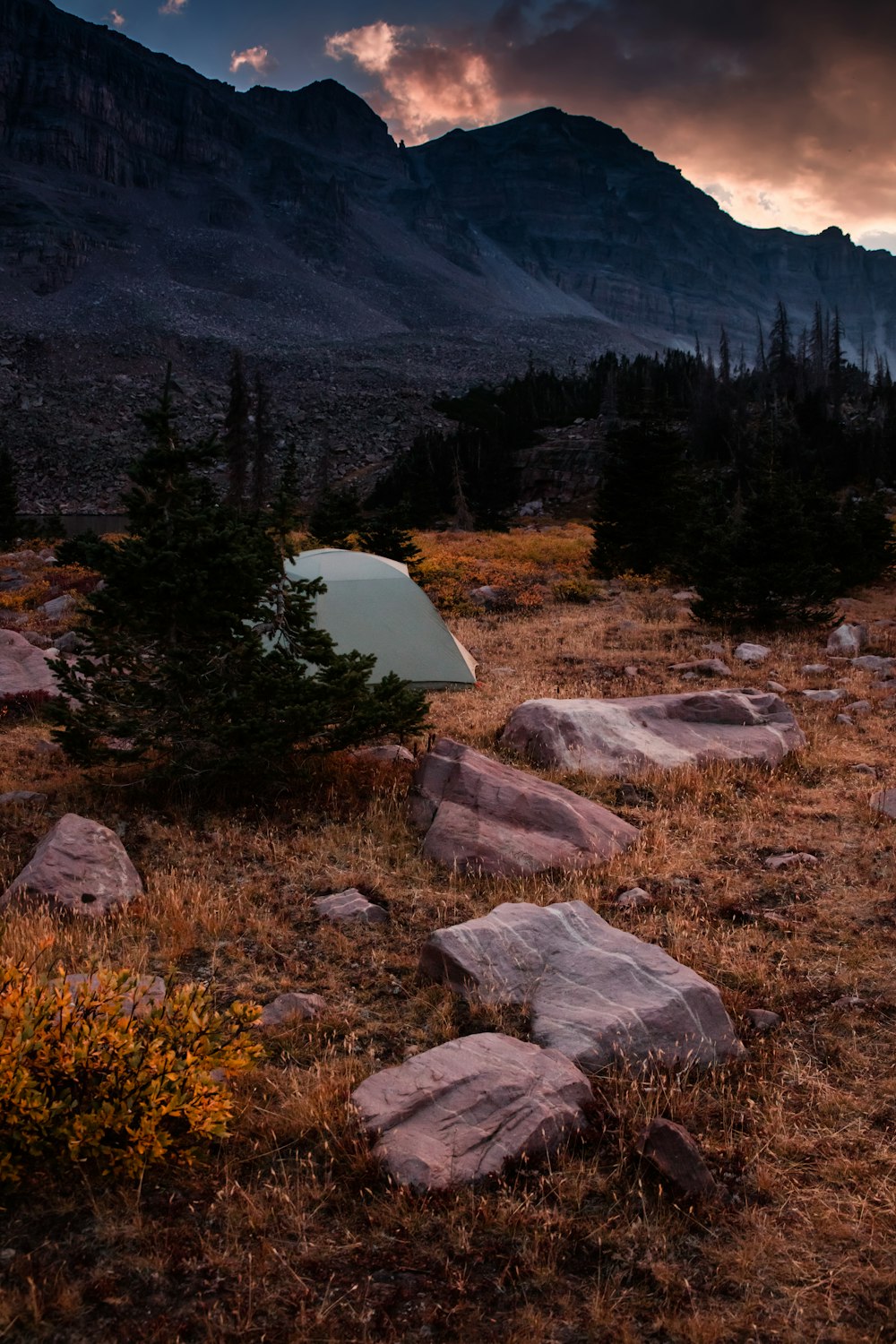 white camping tent near mountain during daytime