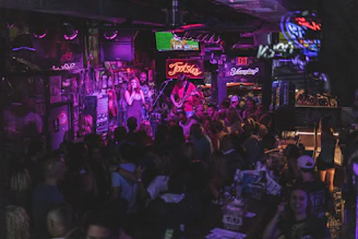 A lively bar scene with friends singing karaoke and enjoying a vibrant night filled with laughter and music.