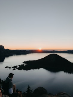 man standing near body of water