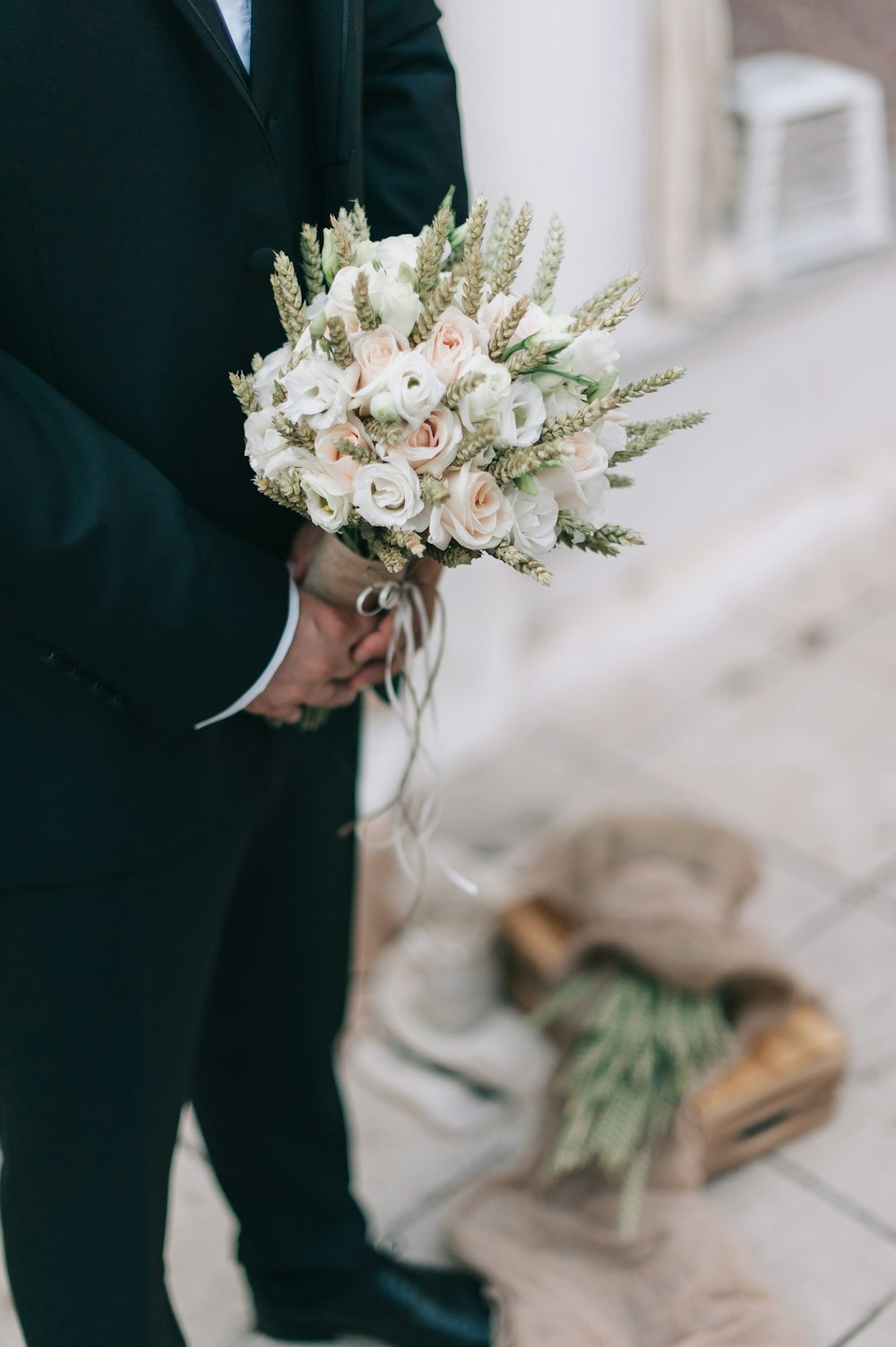 man holding bridal bouquet