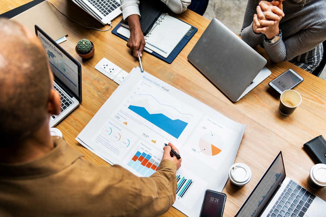 flat lay photography of people discussing about growth chart poster