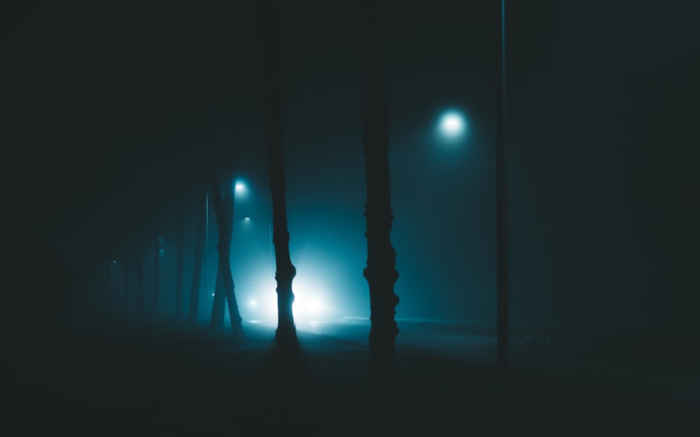 a foggy street at night with street lights