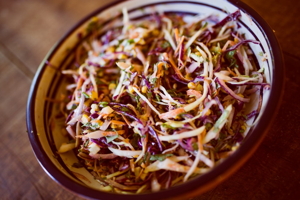 vegetable salad on white and black ceramic bowl