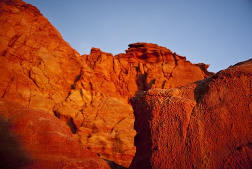Red rock formations glowing in the Valley of Fire under a clear blue sky.
