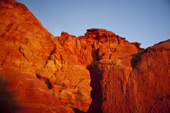 A vibrant painting of Utah's red rock formations under a clear blue sky.