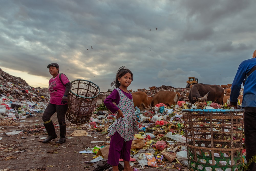 girl standing near garbage