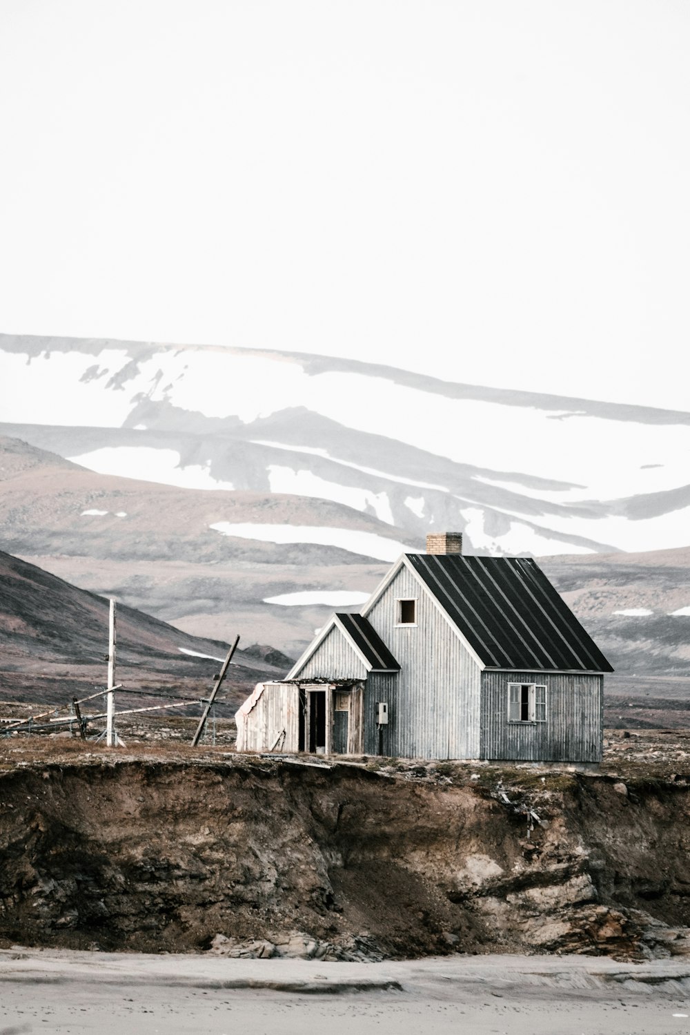 gray house near snow mountain