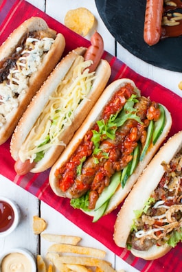 four assorted-type hotdog sandwiches