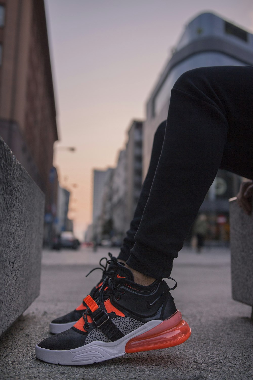 person wearing black-and-gray Nike Air Max 270 shoes