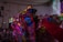 A vibrant music video scene featuring dancers in traditional attire against a colorful backdrop.