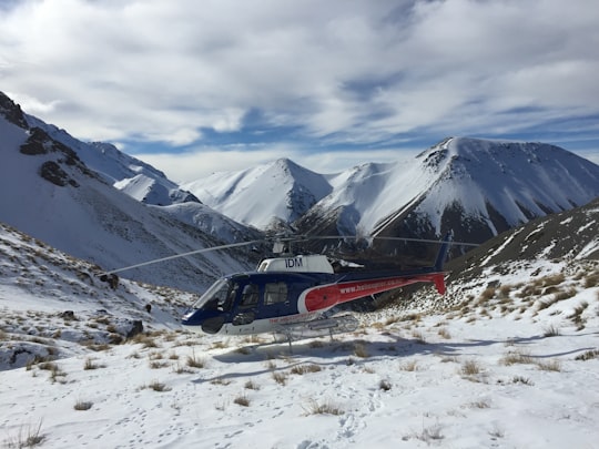 black and red helicopter on mountain in Canterbury New Zealand