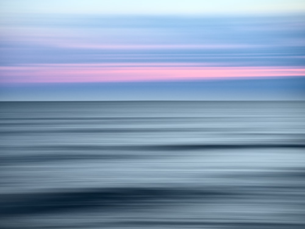 a blurry photo of the ocean at sunset