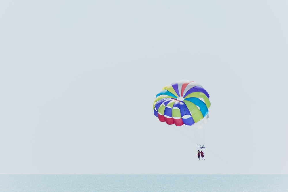 two people paragliding near ocean