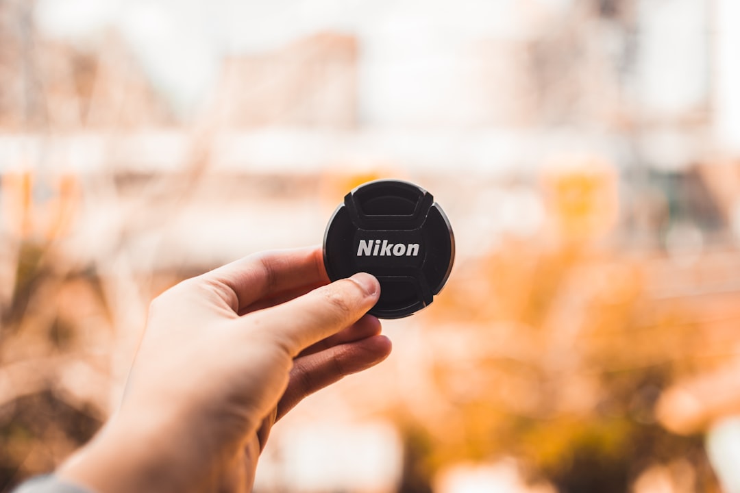 black Nikon lens cover