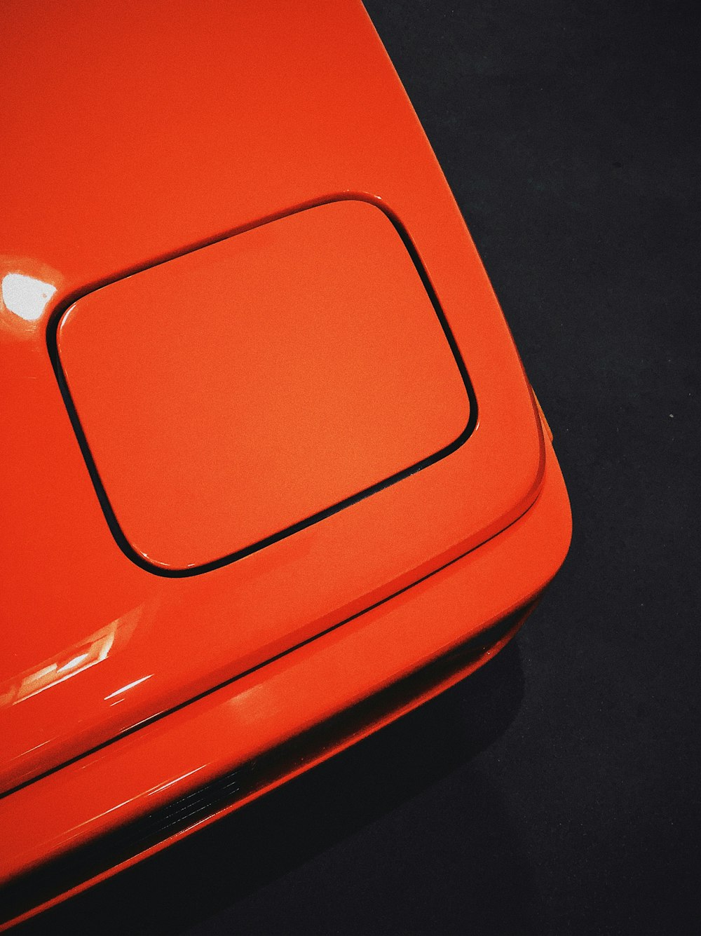 a close up of a red car with a black background