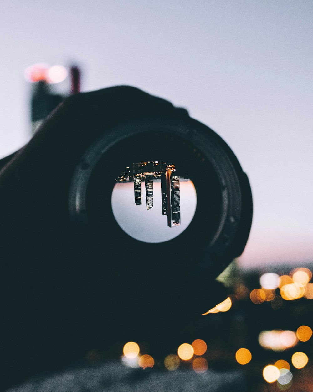 person holding round black lens