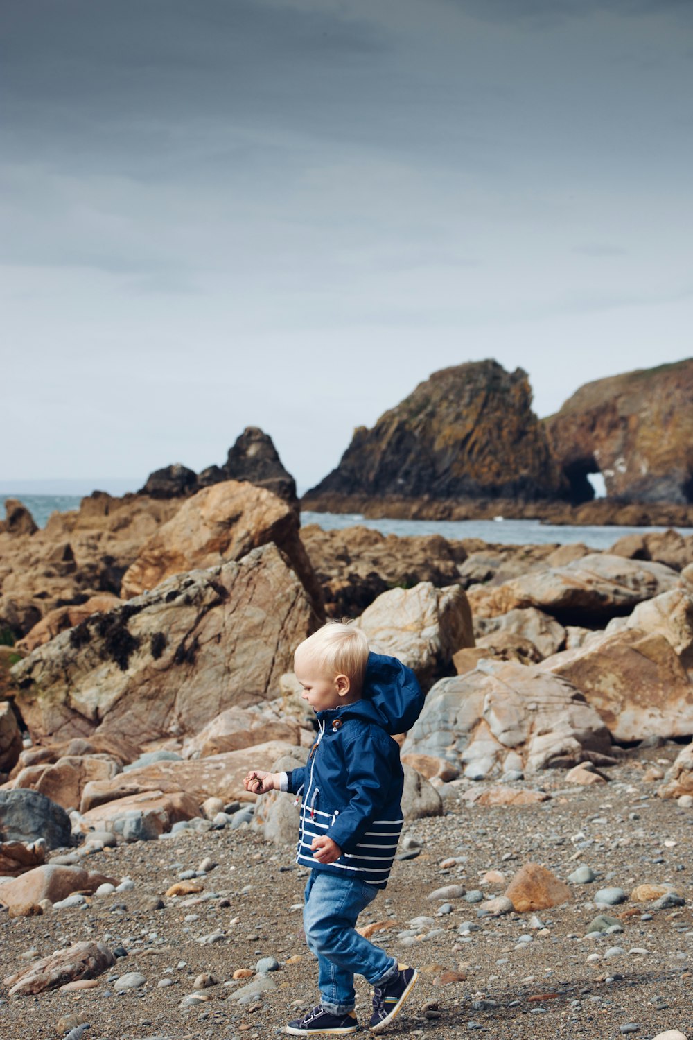 boy walking on ground outdoors