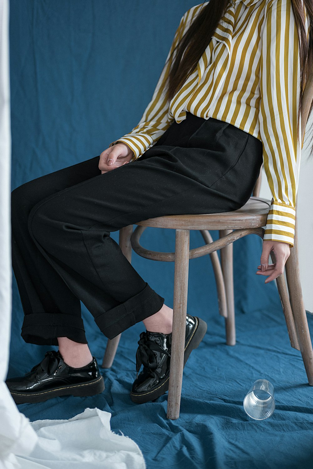 person sitting on brown wooden chair