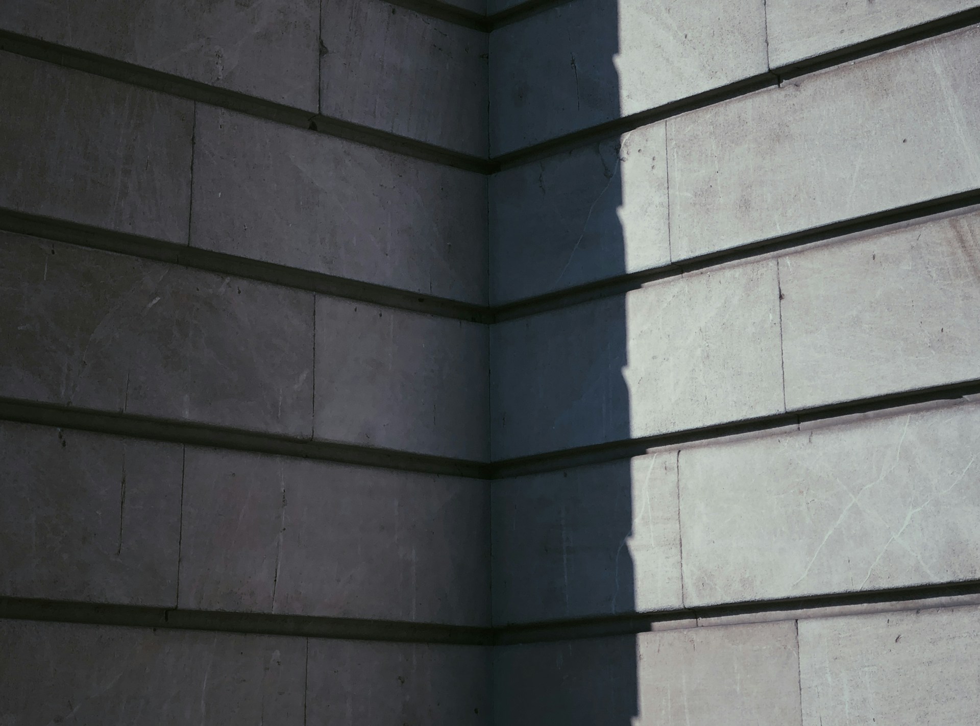 Close-up of textured materials meeting at a subtle, elegant corner detail in a modern building.