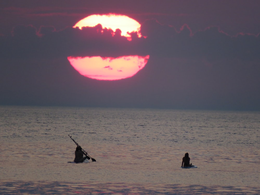 person riding on boat under gray sky during daytime