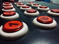 Close-up of a glowing purple arcade button panel with numbers 1 to 6.