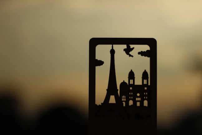 Silhouettes of Van Gogh’s Starry Night blending into a night sky over Paris landmarks.