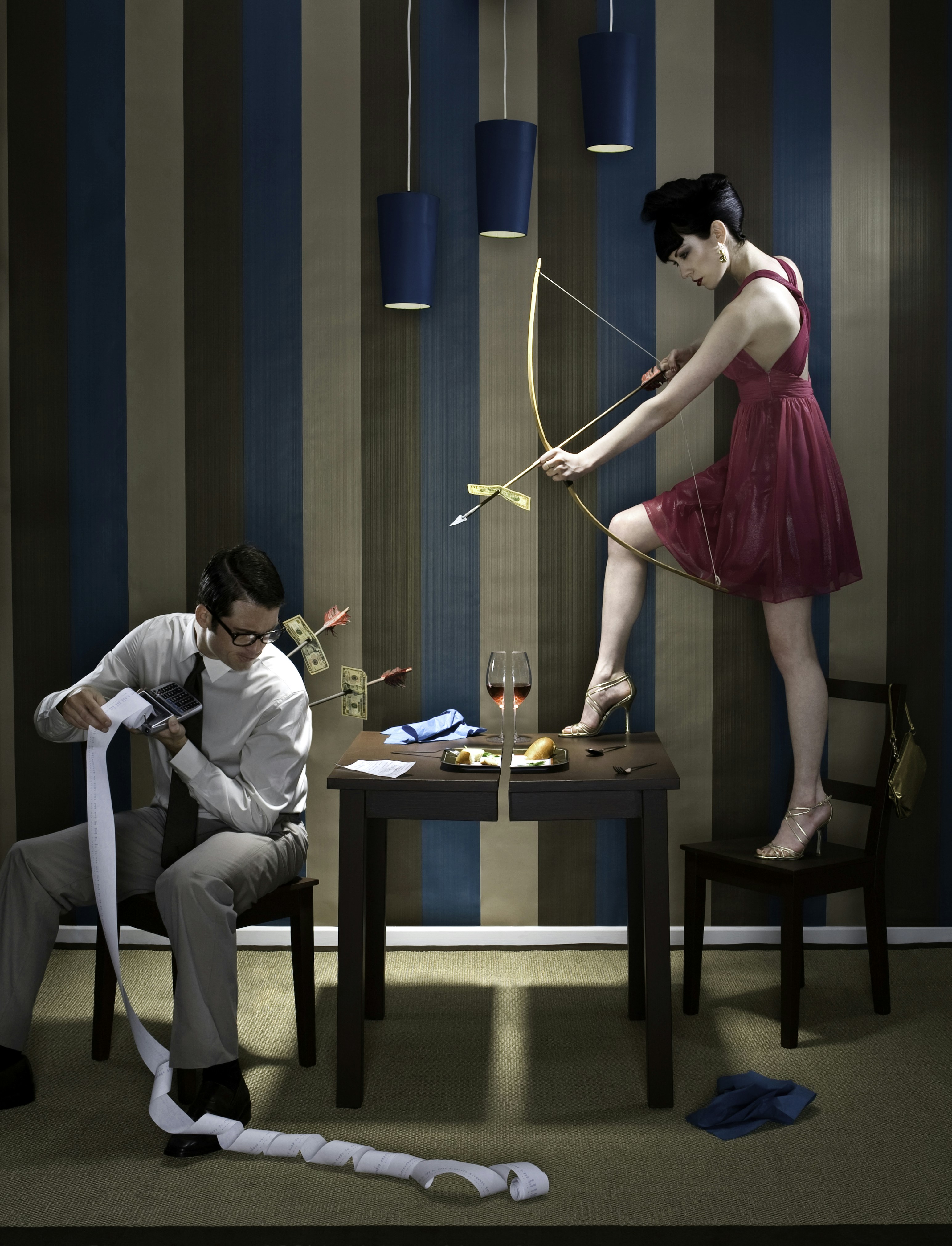 woman holding bow pointing man sitting on chair